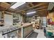 Large shed interior with workbench, exposed ceiling beams and storage at 1703 Ryan Dr, Lutz, FL 33549