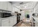 Bright kitchen with white cabinets, hardwood floors, and modern appliances and fixtures at 1703 Ryan Dr, Lutz, FL 33549