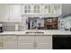 Updated kitchen offers stone countertops, stainless appliances, and opens to the dining room at 1703 Ryan Dr, Lutz, FL 33549