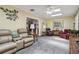 Inviting living room with plush furniture, a ceiling fan, and light-filled skylights at 1703 Ryan Dr, Lutz, FL 33549