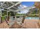 Covered patio includes outdoor kitchen, dining, and pool with brick pavers at 1703 Ryan Dr, Lutz, FL 33549