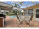Covered patio includes outdoor kitchen, dining area, and pool with pavers at 1703 Ryan Dr, Lutz, FL 33549