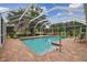 Pool with brick patio is screened for year-round enjoyment at 1703 Ryan Dr, Lutz, FL 33549