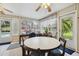 Bright sunroom with tile floors features a casual dining area and views of the pool at 1703 Ryan Dr, Lutz, FL 33549