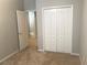 Bedroom featuring neutral walls, carpet, closet with folding doors, and a connecting hallway at 10402 Tulip Field Way, Riverview, FL 33578