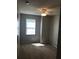 Bedroom with a ceiling fan, carpeted floor, and natural light from the window at 10402 Tulip Field Way, Riverview, FL 33578