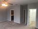 Bedroom featuring neutral walls, carpet, and doorways to the bathroom and walk-in closet at 10402 Tulip Field Way, Riverview, FL 33578
