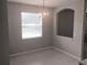 Bright dining room with a chandelier and a large window at 10402 Tulip Field Way, Riverview, FL 33578