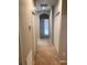 Long hallway with neutral carpet and white doors at 10402 Tulip Field Way, Riverview, FL 33578