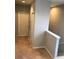 Upstairs hallway featuring carpet, white trim, and two doors at 10402 Tulip Field Way, Riverview, FL 33578