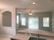 Open-concept living room with lots of natural light and ceiling fan at 10402 Tulip Field Way, Riverview, FL 33578