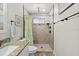 Updated bathroom featuring a shower, a toilet, and a sink offers modern amenities and style at 10515 Hetrick W Cir, Largo, FL 33774
