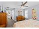 Bright bedroom featuring light blue walls, ceiling fan, and natural wood furniture at 10515 Hetrick W Cir, Largo, FL 33774
