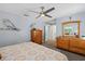 Bright bedroom featuring light blue walls, ceiling fan, and natural wood furniture at 10515 Hetrick W Cir, Largo, FL 33774