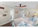 Bright bedroom with a ceiling fan features coastal decor and an ensuite bath for added privacy and convenience at 10515 Hetrick W Cir, Largo, FL 33774