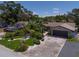Well manicured lawn and landscaping showing mature tropical foliage and a two car garage at 10515 Hetrick W Cir, Largo, FL 33774