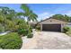 Inviting single-story home with lush tropical landscaping and a two-car garage at 10515 Hetrick W Cir, Largo, FL 33774