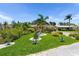Beautifully landscaped front yard with vibrant green grass and mature palm trees enhancing curb appeal at 10515 Hetrick W Cir, Largo, FL 33774
