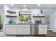Bright kitchen featuring stainless steel appliances, blue countertops, white cabinets, and backyard views at 10515 Hetrick W Cir, Largo, FL 33774