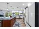 Bright kitchen with stainless steel appliances, light wood floors, large island, and sliding doors to the backyard at 10515 Hetrick W Cir, Largo, FL 33774