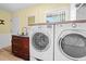 Modern laundry room with front-loading washer and dryer provides convenience and functionality at 10515 Hetrick W Cir, Largo, FL 33774