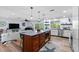 Bright, open layout connecting the living room to the kitchen with center island at 10515 Hetrick W Cir, Largo, FL 33774