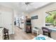 This living room features a classic arcade game and an open view of the kitchen at 10515 Hetrick W Cir, Largo, FL 33774