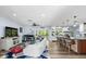 Bright, open-concept living area flowing into the kitchen with hardwood floors at 10515 Hetrick W Cir, Largo, FL 33774