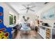 This living room boasts a coastal theme, guitars, and a view to the backyard at 10515 Hetrick W Cir, Largo, FL 33774