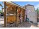 Rustic outdoor shower area with wooden enclosure and stone flooring, offering privacy and charm at 10515 Hetrick W Cir, Largo, FL 33774
