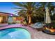 Resort-style pool area with a hammock, outdoor bar, and lush landscaping, perfect for relaxation at 10515 Hetrick W Cir, Largo, FL 33774
