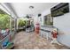 The sunroom has tile floors, a ceiling fan, a TV, a shark statue, and a view to the backyard at 10515 Hetrick W Cir, Largo, FL 33774
