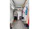 Organized walk-in closet with shelving and clothing racks offers ample storage space and easy access at 10515 Hetrick W Cir, Largo, FL 33774