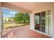 Covered brick patio with a screen enclosure featuring views of the lush backyard and mature trees at 10855 Cory Lake Dr, Tampa, FL 33647