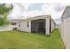 Expansive backyard view showcasing the home's exterior and screened in patio at 11830 Brighton Knoll Loop, Riverview, FL 33579