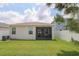 Expansive backyard view showcasing the home's exterior and screened in patio at 11830 Brighton Knoll Loop, Riverview, FL 33579