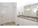 Bright bathroom features a double sink vanity with a gray countertop and white cabinets at 11830 Brighton Knoll Loop, Riverview, FL 33579