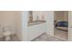 Well-lit bathroom features a dual sink vanity and a separate toilet room at 11830 Brighton Knoll Loop, Riverview, FL 33579