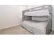 Cozy bedroom features a bunk bed with a gray frame and patterned bedding at 11830 Brighton Knoll Loop, Riverview, FL 33579