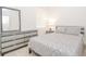 Bright bedroom has a gray bed set, dresser, and a large mirror at 11830 Brighton Knoll Loop, Riverview, FL 33579