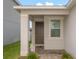 Inviting front entrance with a classic brown door, decorative columns, and verdant landscaping at 11830 Brighton Knoll Loop, Riverview, FL 33579