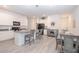 Bright kitchen features white cabinetry, a central island with bar seating, and stainless steel appliances at 11830 Brighton Knoll Loop, Riverview, FL 33579