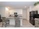 Modern kitchen features a breakfast bar, white cabinets, stainless steel appliances, and tile flooring at 11830 Brighton Knoll Loop, Riverview, FL 33579