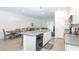 Open-concept kitchen with an island, gray countertop, dishwasher, and adjacent dining area at 11830 Brighton Knoll Loop, Riverview, FL 33579