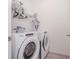 Bright laundry room equipped with new washer and dryer, plus ample shelving at 11830 Brighton Knoll Loop, Riverview, FL 33579