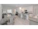Open-concept kitchen and dining area featuring white cabinets, gray countertops, and modern appliances at 11830 Brighton Knoll Loop, Riverview, FL 33579