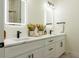 Modern bathroom featuring double sinks, lighted mirrors, and stylish black fixtures at 12484 Cross St, Largo, FL 33773