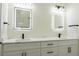 Modern bathroom featuring double sinks, lighted mirrors, and stylish black and gold fixtures at 12484 Cross St, Largo, FL 33773