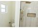 Modern bathroom featuring a glass shower with gold fixtures and a stylish tile surround at 12484 Cross St, Largo, FL 33773