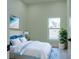 Bright bedroom featuring a queen bed, vibrant artwork, and a lush potted plant at 12484 Cross St, Largo, FL 33773